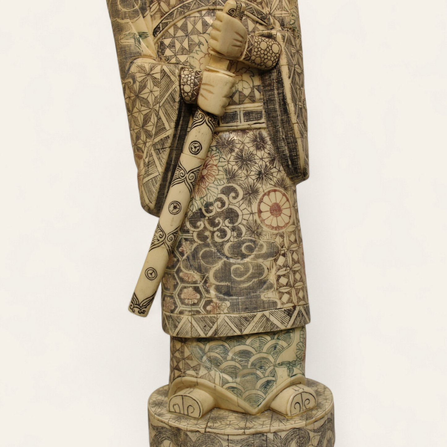 Standing Elder Chinese man with sword bone relief statue